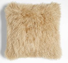 a fluffy beige pillow on a white background with no one in it or someone else