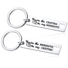 two metal key chains with the words you're the meredith on them