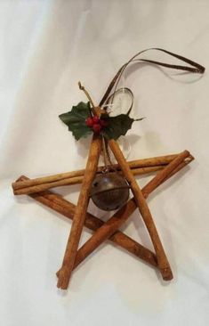 a wooden star ornament with holly and bells