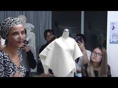 a group of women standing around a mannequin