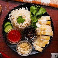 a plate with rice, cucumber, and other foods on it