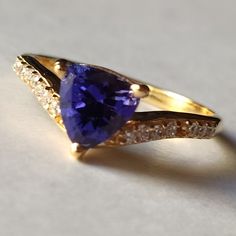 Material  14k Yellow Gold  . Gemstone  Natural Tanzanite  . Gemstone Colour  Blue  . Gemstone Shape  Trillion  . Gemstone Size  6x6MM . birthstone  December  . Cut Grade  Excellent . Style  Art Deco Blue Gemstone Ring, Tanzanite Engagement Ring, December Birthstone Ring, Tanzanite Gemstone, Natural Tanzanite, December Birthstone, Gift Jewelry, Jewelry Ring, Gold Engagement Rings