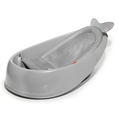 a baby bath tub with a whale design on the top and bottom, sitting in front of a white background