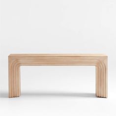 a wooden bench sitting on top of a white floor