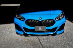 the front end of a blue sports car