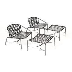 four metal chairs sitting next to each other