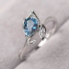 ◆ The ring is handcrafted from sterling silver and decorated with a dazzling 5*7 mm London blue topaz and CZs. It is suitable for engagement/anniversary/daily occasion. ◆ Production Description: Main stone Type: Real London Blue Topaz Main Stone Shape: Pear Cut Main Stone Size: 5*7 mm(0.97ct) Side stone: CZ Metal: 925 Sterling silver - Other options available in the drop down menu ◆ Customization: √Free for Add Engraving √Other Metal Type Available √Other Gemstones & Shapes Available √Person Diamond White Blue Topaz Ring For Gifting, Blue White Topaz Ring For Promise, Diamond-accented Topaz Ring As A Gift, Diamond Topaz Ring With Gemstone Accents For Gift, Silver Diamond Ring With Blue Topaz And Gemstone Accents, Blue Topaz Birthstone Diamond Ring, Silver Topaz Wedding Ring With Gemstone Accents, White Gold Topaz Ring With Gemstone Accents For Anniversary, White Topaz Birthstone Ring Gift