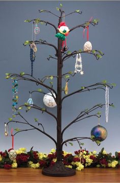 a christmas tree with ornaments hanging from it's branches and decorations on the top