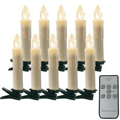 a set of twelve white candles with remote controls