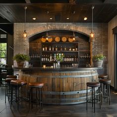 a bar with wooden barrels and stools