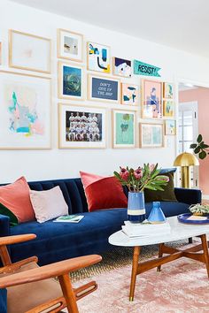 a living room filled with furniture and pictures on the wall