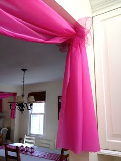 an image of a room decorated with pink ribbon