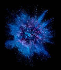 blue and pink powder exploding in the dark