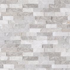 a white and grey tile wall that looks like it is made out of stone