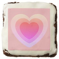 a square piece of cake with frosting in the shape of a heart on it