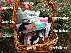 a wicker basket filled with various items in front of some flowers and bushes,