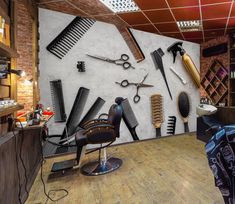 a barber shop with scissors and combs on the wall