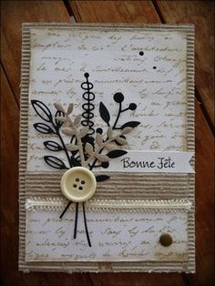 a close up of a button on a card with buttons and flowers in the middle