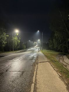 an empty street at night with no cars on it