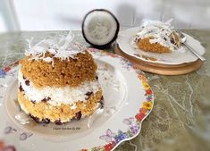 there is a cake on the plate with coconut and other food items around it that are ready to be eaten