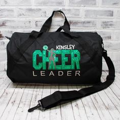 This personalized CHEER travel bag with Shimmer Green applique is ready to hold all your stuff whether for after school practice, competitions or even a weekend at grandma's! Add a name for a super personalized on the go bag. With a design you won’t find anywhere else, Persunly duffle bags show off your favorite activity, while keeping all your gear handy and protected. Our three sizes are roomy and fit shoes, clothing, balls, and small sporting equipment. Made from a sturdy denier polyester canvas, and with tough zippers and straps, these totes and duffles are built to last. CUSTOM BAG OPTIONS: Custom bag style: Tote, Small Duffle, or Large Duffle. Dimensions listed below. Custom bag color: Drop down menu options are available based on what coordinates with the design colors. Not all desi Personalized Sporty School Bag, Sporty Personalized School Bag, Black School Spirit Bag For College, Customizable School Spirit Bag For Everyday, Customizable School Spirit Bags For Everyday Use, Personalized Black Bags For Back To School, Customizable School Spirit Bags, Cheer Team Gift, On The Go Bag