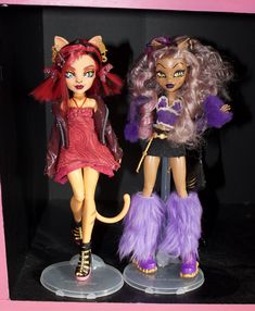 two monster dolls are standing next to each other