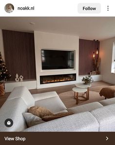 a living room filled with furniture and a flat screen tv mounted on the wall above a fire place