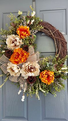 an orange and white wreath on a blue door