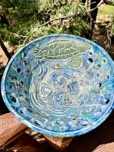 a blue bowl with a turtle painted on it