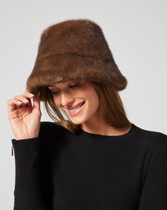 This bucket hat is a true outfit-maker: it's rendered in faux mink fur, so it looks good even as temps drop. Fur Bucket, Faux Fur Bucket Hat, Fur Bucket Hat, Jumpsuit Jacket, Outerwear Vest, Outfit Maker, Mink Fur, Hats For Sale, Sweater Skirt