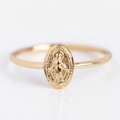 It is believed that a person wearing the medal will receive protection and graces from the Virgin Mary herself. If the wearer beholds this medal with confidence, they can expect their prayers and faith to be heard. 14k solid yellow gold Height 8 mm Band width 1 mm Stamped 14k Gold Spiritual Jewelry And Charms, 14k Gold Spiritual Jewelry And Charms For Commemoration, Spiritual 14k Gold Halo Jewelry, 14k Gold Spiritual Miraculous Medal Jewelry And Charms, 14k Gold Spiritual Miraculous Medal Jewelry, Yellow Gold Spiritual Jewelry For Anniversary, 14k Yellow Gold Jewelry With Miraculous Medal, 14k Gold Miraculous Medal As A Gift, 14k Gold Miraculous Medal As Gift