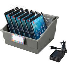 an open box with five ipads in it and a charger plugged into the back