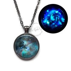 "Shine bright with our Glow in the Dark Orion Galaxy Pendant Necklace! Choose from 4 metal finishes, 2 Sizes and 2 stunning images of the galaxy. Perfect for astronomy enthusiasts or sci-fi lovers, this pendant features a glowing constellation of stars to add a touch of celestial magic to your style. Looking for a unique gift for the star-gazing enthusiast in your life? Look no further! Our product is the perfect keepsake for anyone interested in astronomy and astrology. Whether it's for a man or woman, student or teacher, this gift is sure to bring a smile to their face. Custom Choices: 4 metal finishes available:  Silver, Antique Bronze, Antique Copper or Gunmetal. Choose between a \"Blue\" or \"Red\" colored galaxy. Pendant Size: 20mm (.76 inches) or 25mm (1 inch) Style: Necklace or Key Space-themed Black Jewelry Gift, Magical Luminous Blue Jewelry, Orion Galaxy, Astronomy Jewelry, Space Astronomy, Celestial Magic, Galaxy Necklace, Galaxy Pendant, Orion Nebula