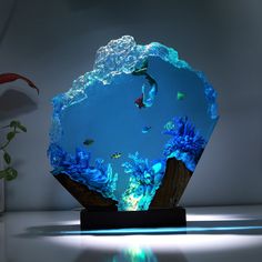 an aquarium with fish and corals in it