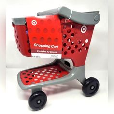 a red shopping cart with black wheels and white polka dots on the bottom, has a tag that says shopping cart