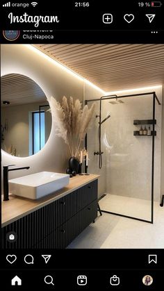 an instagram photo of a bathroom with a sink, mirror and shower in it