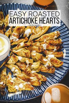 artichoke hearts on a blue plate with orange juice in the background and text overlay that reads easy roasted artichoke hearts