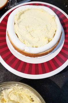 there is a plate with cake on it and another plate with bread in the background