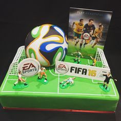 a cake with soccer players on it and a dvd in the backgroung