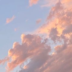 an airplane is flying in the sky at sunset or dawn with pink clouds and blue sky