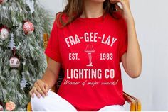 Frageelay Lighting Co Bella Canvas Shirt Perfect for any Christmas Story fan!  It's a major award! This classic unisex jersey short sleeve tee fits like a well-loved favorite. Soft cotton and quality print make users fall in love with it over and over again. These t-shirts have-ribbed knit collars to bolster shaping. The shoulders have taping for better fit over time. Dual side seams hold the garment's shape for longer. .: 100% Airlume combed and ringspun cotton (fiber content may vary for diffe A Christmas Story Shirt, A Christmas Story Movie, Tradition Ideas, Christmas Story Movie, Oh Fudge, Leg Lamp, Party 2023, Christmas Tradition, Funny Vintage