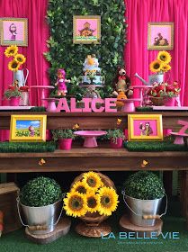 the table is decorated with sunflowers and other decorations for a children's birthday party