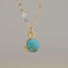 Natural bitsy turquoise electroplated in recycled brass with 24K gold overlay. Hangs delicately from a 14K gold filled 18" chain. Approx. 6mm in size. Turquoise embraces and emits healing properties of communication, inspiration, and enthusiasm. Dainty Handmade Gold Turquoise Necklace, Handmade Dainty Gold Turquoise Necklace, Dainty Gold Turquoise Necklace As Gift, Gold Minimalist Turquoise Necklace Gift, Dainty Yellow Gold Turquoise Necklace For Gift, Handmade Gold Turquoise Necklace With Round Pendant, Handmade Turquoise Necklace With Round Gold Pendant, Gold Turquoise Necklace For Healing And Spirituality, Turquoise Birthstone