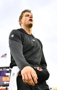 a man in black jersey holding a white frisbee