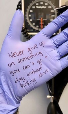 a gloved hand with writing on it that says never give up on something you can't go through without thinking about