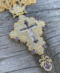 Pectoral Cross Pendant Jesus Priest Bishop Purple Crystallized Stones Devotional clergy Pectoral Cross with small clear crystallized glass elements Purple semi-precious stones.Religious Cross with Jesus enamel image, a long 23" elegant golden chain necklace with closure, worn as a vestment by Orthodox and Eastern Catholic bishops.Clergy Cross pendant length (H X W): 15.5 cm x 8 cm / 6" x 3.5" , Chain Length: 60 cm / 23". Packed in a beautiful gift box with a velvet base to provide extra protecti Luxury Purple Jewelry Gift, Luxury Purple Jeweled Jewelry, Rhinestone Cross Pendant Jewelry Gift, Spiritual Pendant Jewelry For Souvenir, Spiritual Silver Jewelry Souvenir, Spiritual Souvenir Pendant Jewelry, Handmade Amethyst Gold Necklace, Handmade Gold Amethyst Necklace, Gold Jeweled Jewelry Gift