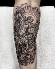 a man's leg with an angel tattoo on it