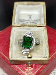 Here we have an amazing modern statement ring featuring a unique floral design set with sparkling Swarovski Zirconia Gemstones in sterling silver marked 925 UK size - L US size - 5.75  face length approx - 22mm Message me any questions  ITEM - S1990 Silver Cubic Zirconia Emerald Ring For Formal Occasions, Formal Silver Emerald Ring With Cubic Zirconia, Sterling Silver Emerald Ring With Diamond Accents As Gift, Gift Emerald Ring With Diamond Accents In Sterling Silver, Party Sterling Silver Ring With Center Stone, Dazzling Sterling Silver Emerald Ring For Formal Occasions, Green Sterling Silver Rings For Party, Formal Hallmarked Emerald Cubic Zirconia Ring, Dazzling Sterling Silver Emerald Ring