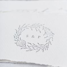 the monogrammed logo is on top of an old piece of paper