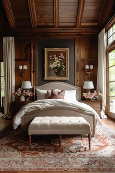 a large bed sitting in a bedroom on top of a wooden floor next to two lamps